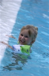 child in pool with floaties on