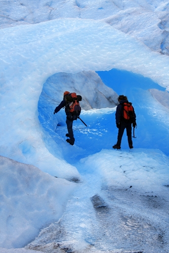 two men exploring ice cave