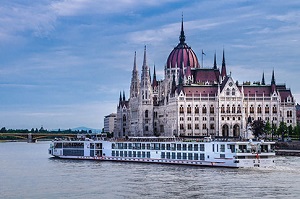 River cruise ship passing castle on European river