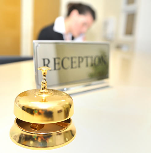 Gold bell at reception desk in hotel